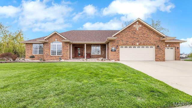 304 Wood Duck Ct, Waterloo, IL 62298 - view of front of property with an attached garage, driveway, brick siding, and a front lawn