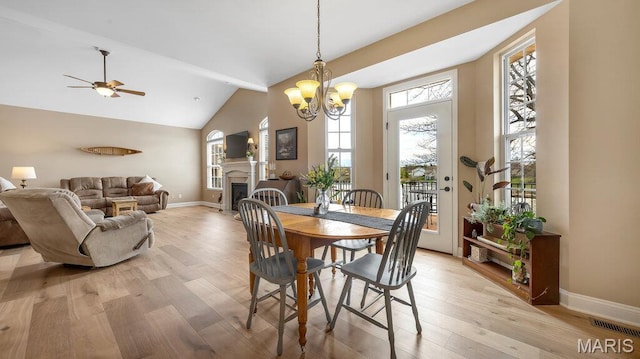 304 Wood Duck Ct, Waterloo, IL 62298 - dining room featuring light wood finished floors, ceiling fan, vaulted ceiling, baseboards, and a chandelier