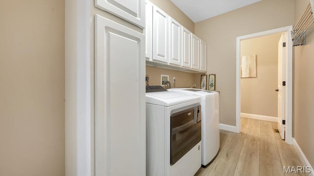 304 Wood Duck Ct, Waterloo, IL 62298 - clothes washing area with washing machine and dryer, cabinet space, light wood-type flooring, and baseboards