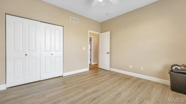 304 Wood Duck Ct, Waterloo, IL 62298 - unfurnished bedroom featuring light wood-style floors, baseboards, a closet, and a ceiling fan