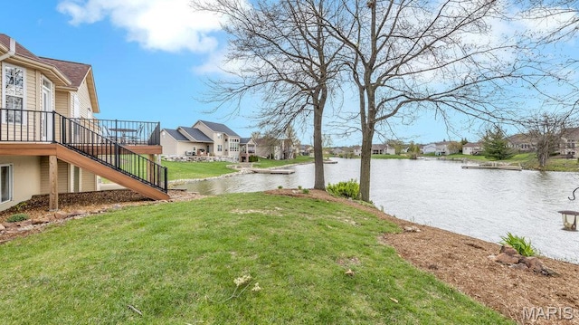 304 Wood Duck Ct, Waterloo, IL 62298 - view of grassy yard with stairs, a residential view, and a deck with water view