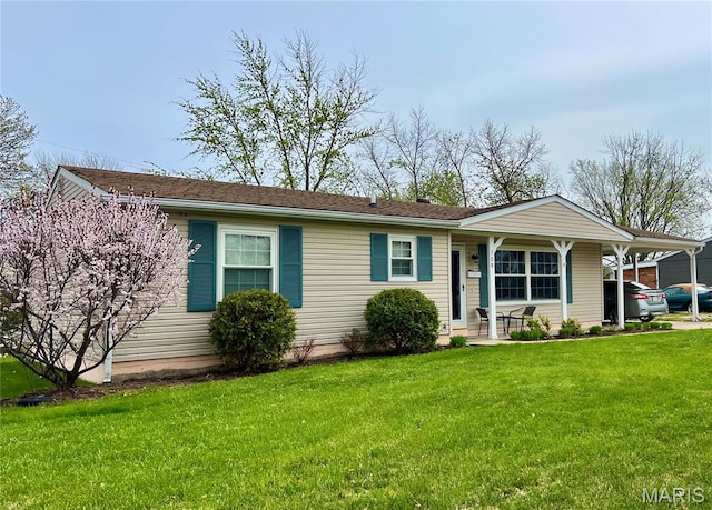view of front of house featuring a front yard, covered porch, and a carport