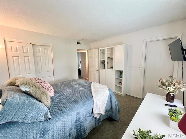 bedroom featuring dark colored carpet and a closet