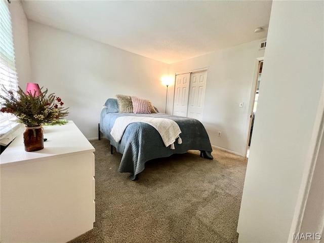 carpeted bedroom with a closet