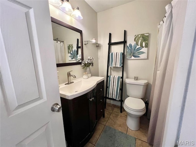 full bath with tile patterned flooring, vanity, and toilet