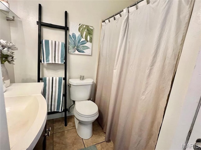 bathroom with vanity, toilet, and tile patterned floors