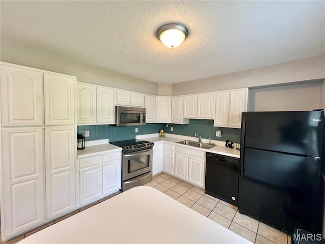 kitchen featuring black appliances, a sink, light countertops, white cabinets, and a textured ceiling