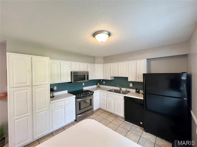 kitchen with black appliances, a sink, white cabinetry, light countertops, and a textured ceiling