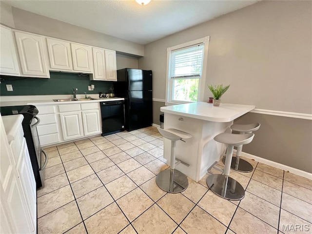 kitchen with black appliances, a sink, light countertops, white cabinets, and light tile patterned floors
