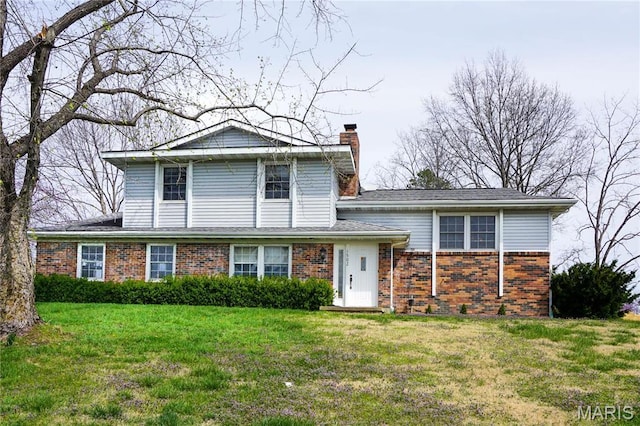 1502 Independence Rd, Rolla, MO 65401 - view of front facade featuring brick siding, a front lawn, and a chimney