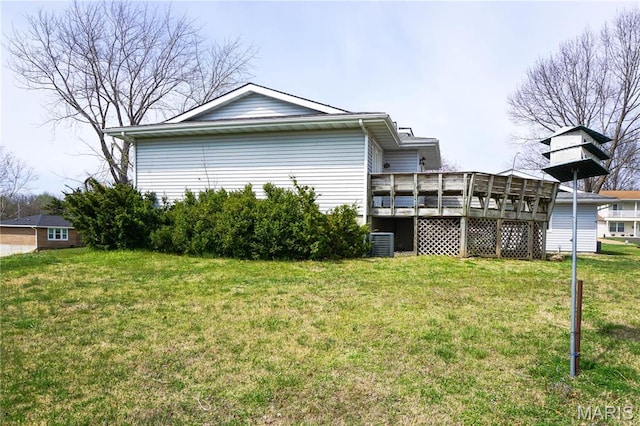 1502 Independence Rd, Rolla, MO 65401 - rear view of house with a wooden deck, a lawn, and central AC unit