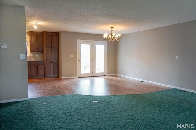 1502 Independence Rd, Rolla, MO 65401 - carpeted spare room with a chandelier, baseboards, and a textured ceiling