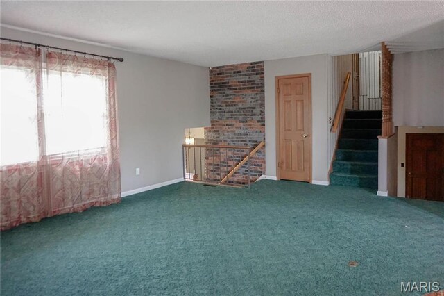 1502 Independence Rd, Rolla, MO 65401 - unfurnished living room featuring a textured ceiling, carpet, stairs, and baseboards