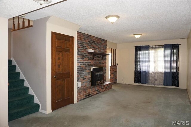 1502 Independence Rd, Rolla, MO 65401 - unfurnished living room with carpet floors, a textured ceiling, stairway, and a brick fireplace
