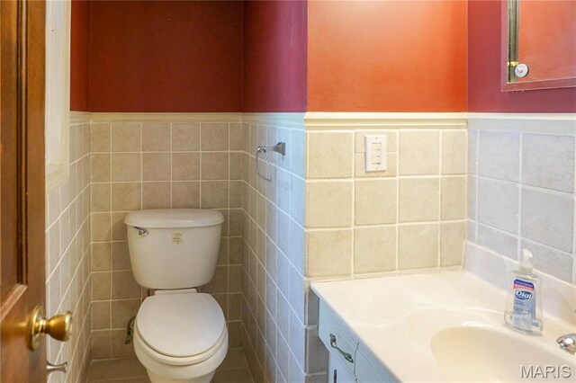 1502 Independence Rd, Rolla, MO 65401 - bathroom with tile walls, vanity, toilet, and a wainscoted wall