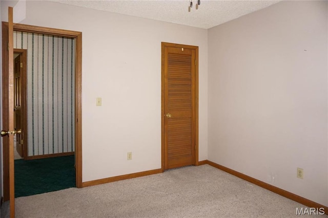 1502 Independence Rd, Rolla, MO 65401 - empty room featuring carpet, a textured ceiling, and baseboards