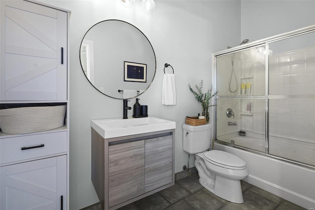 bathroom featuring toilet, vanity, and shower / bath combination with glass door