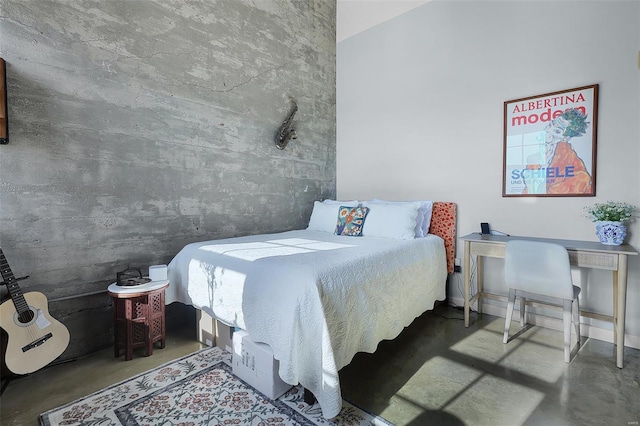 bedroom featuring finished concrete flooring