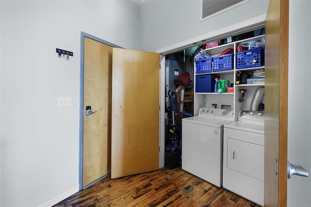 laundry area featuring washer and clothes dryer and wood finished floors