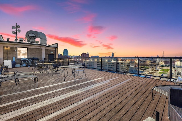 deck at dusk with outdoor dining area