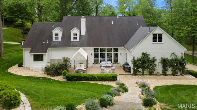 323 White Oaks Ln, Cape Girardeau, MO 63701 - rear view of property featuring a patio, a chimney, a yard, and a shingled roof