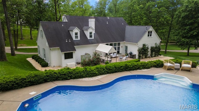 323 White Oaks Ln, Cape Girardeau, MO 63701 - outdoor pool with a patio, outdoor lounge area, a yard, and view of wooded area