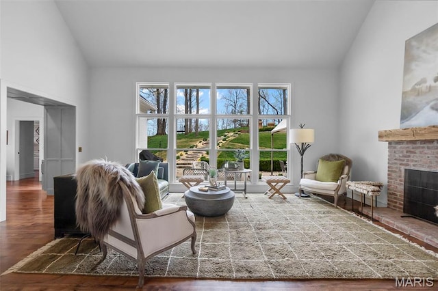 323 White Oaks Ln, Cape Girardeau, MO 63701 - living room featuring a brick fireplace, plenty of natural light, high vaulted ceiling, and wood finished floors