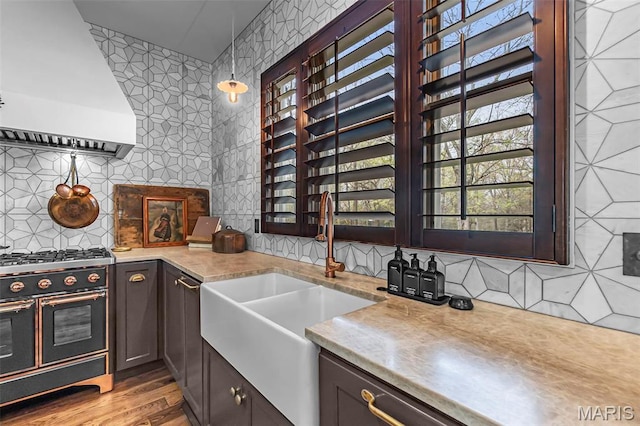 323 White Oaks Ln, Cape Girardeau, MO 63701 - kitchen featuring custom exhaust hood, range with two ovens, a sink, and tasteful backsplash