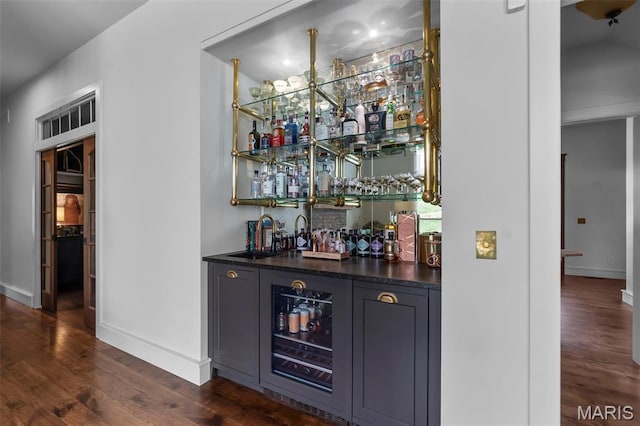323 White Oaks Ln, Cape Girardeau, MO 63701 - indoor wet bar with dark wood-style flooring and baseboards