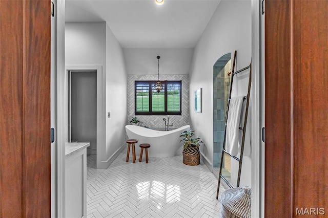323 White Oaks Ln, Cape Girardeau, MO 63701 - full bath featuring a soaking tub, baseboards, a shower, and a chandelier