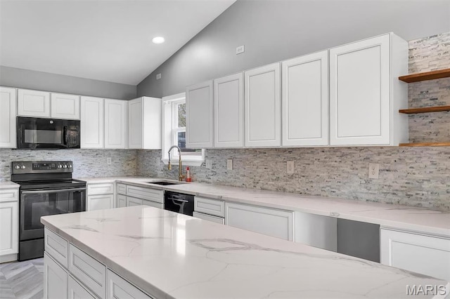 283 Sonnet Cir, Wentzville, MO 63385 - kitchen featuring black appliances, a sink, white cabinets, light stone countertops, and high vaulted ceiling