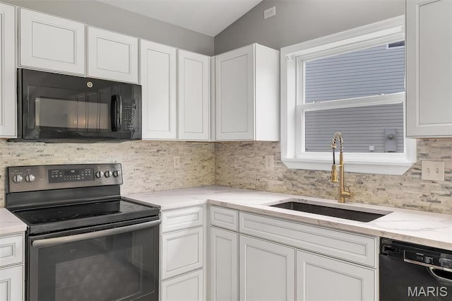 283 Sonnet Cir, Wentzville, MO 63385 - kitchen with black appliances, a sink, white cabinetry, decorative backsplash, and vaulted ceiling