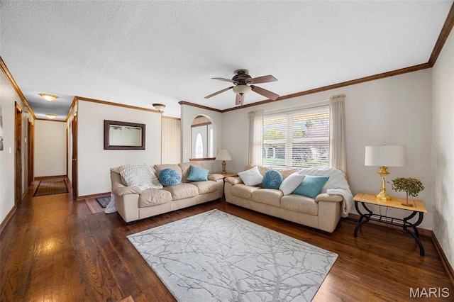 living room featuring ornamental molding, ceiling fan, wood finished floors, baseboards, and a textured ceiling
