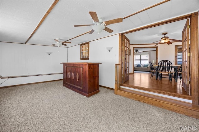 bonus room featuring carpet floors, ceiling fan, and baseboards