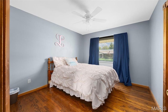 bedroom with wood finished floors, baseboards, and ceiling fan
