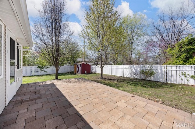 view of patio / terrace with a storage shed and an outbuilding