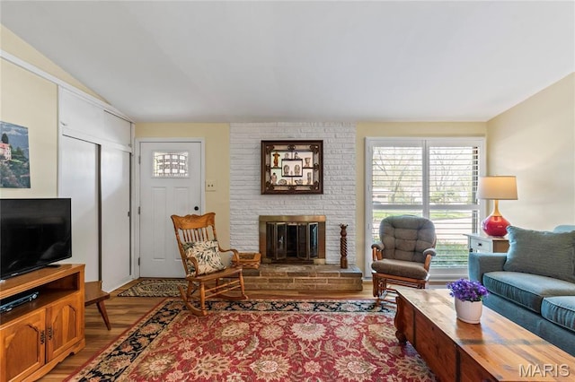 1500 Ridgewood Dr, Saint Louis, MO 63126 - living area with a brick fireplace, wood finished floors, and vaulted ceiling