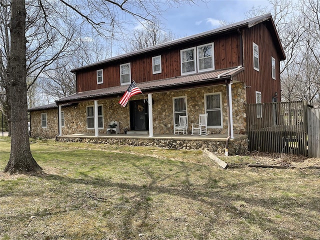 676 Frontier Ln, Bourbon, MO 65441 - view of front of home featuring stone siding, a porch, metal roof, and a standing seam roof