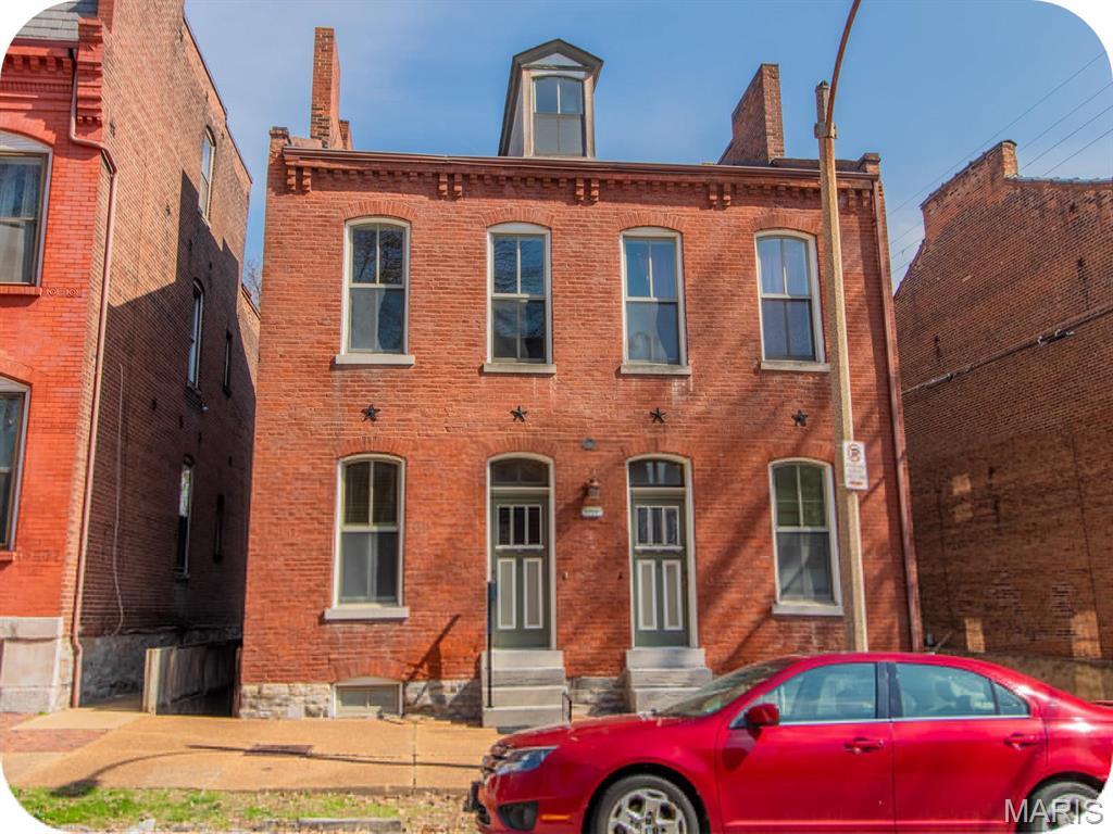 1217 Lami St, Saint Louis, MO 63104 - italianate home featuring entry steps, brick siding, and a chimney