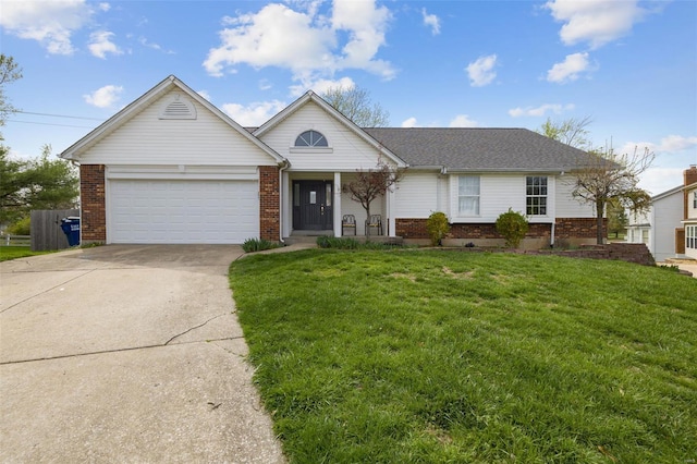 view of front facade with brick siding, concrete driveway, an attached garage, and a front yard