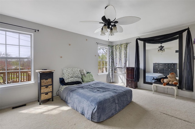 carpeted bedroom with baseboards and a ceiling fan
