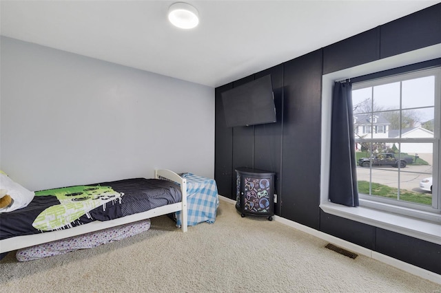 bedroom featuring carpet flooring, multiple windows, and baseboards