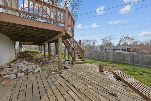 wooden terrace featuring a fenced backyard and stairway
