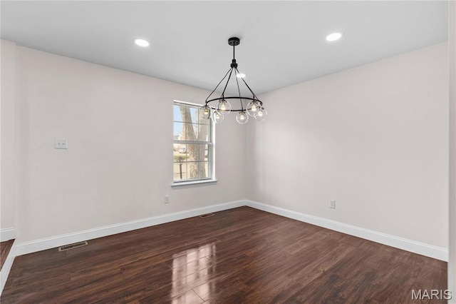 unfurnished room with dark wood finished floors, baseboards, a chandelier, and recessed lighting