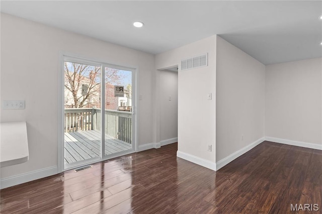 unfurnished room featuring wood finished floors, baseboards, and recessed lighting