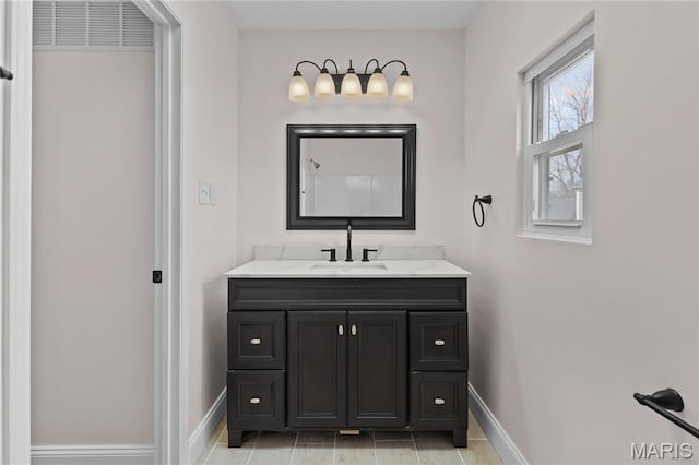 bathroom featuring baseboards and vanity