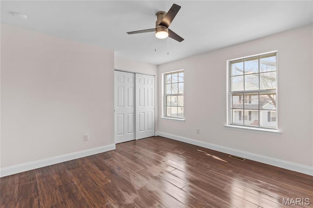 unfurnished bedroom featuring baseboards and wood finished floors