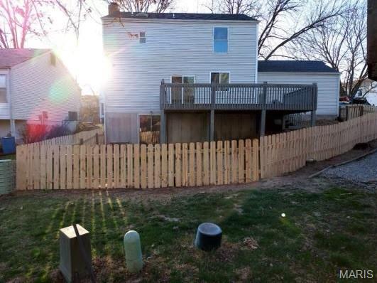 back of house with a deck
