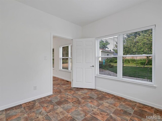 602 S Ballas Rd, Saint Louis, MO 63122 - spare room featuring baseboards and stone finish flooring
