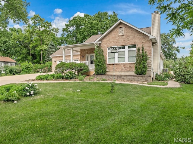 602 S Ballas Rd, Saint Louis, MO 63122 - view of front of home with brick siding, a chimney, a front lawn, and driveway